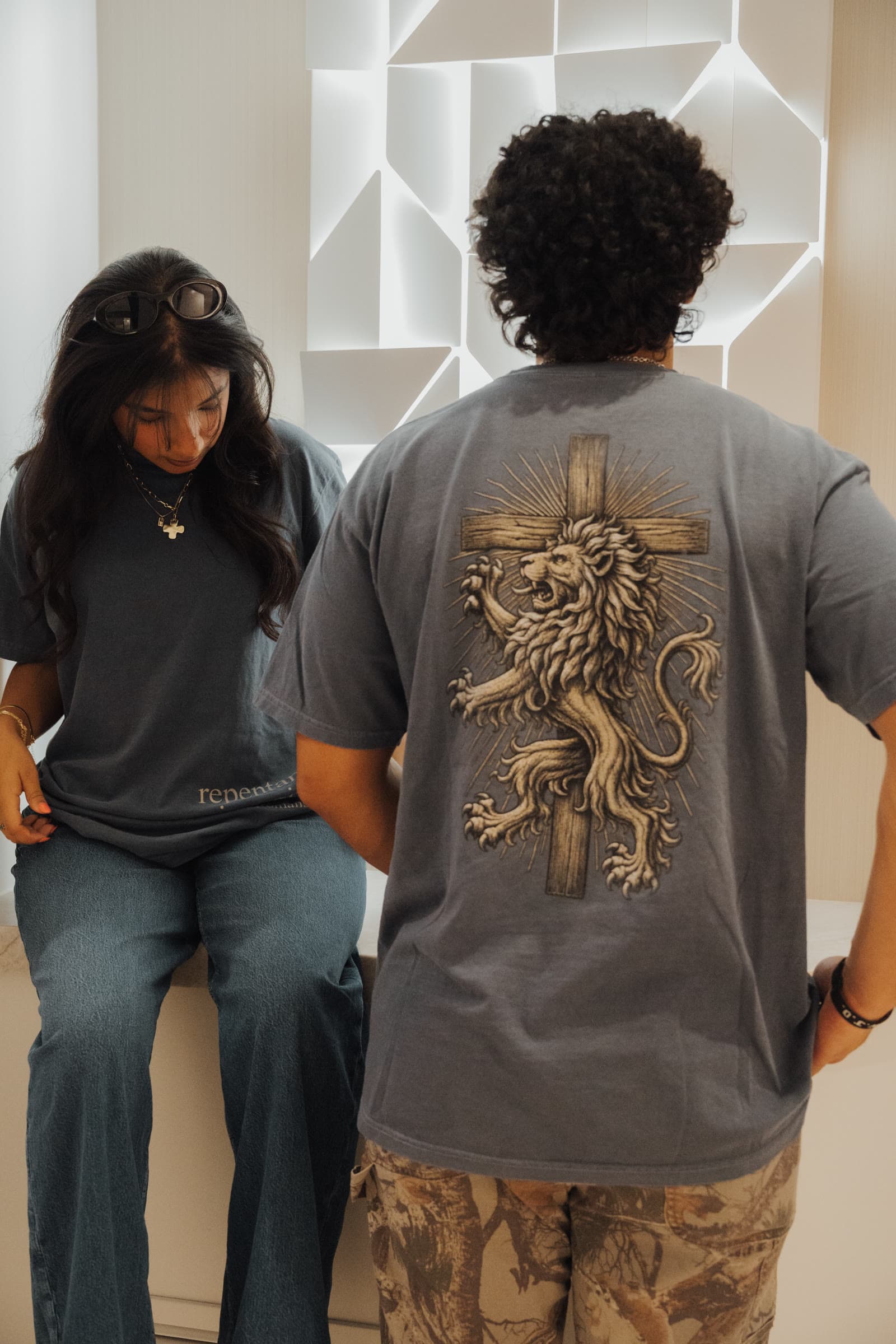 Back of the slate tee: an engraved lion standing before the cross