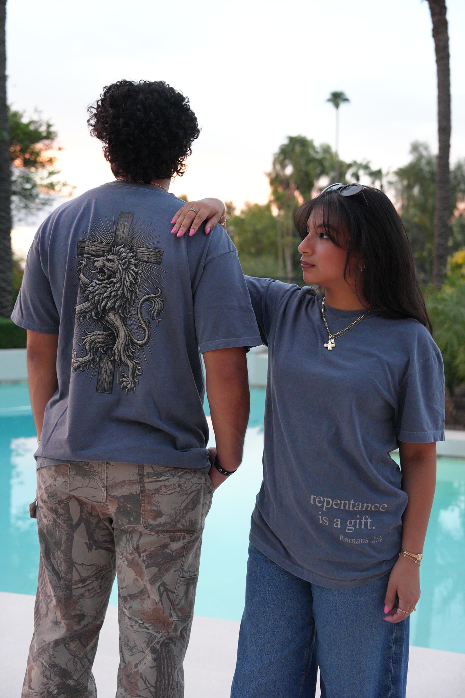 Two friends wearing the tee, front and back